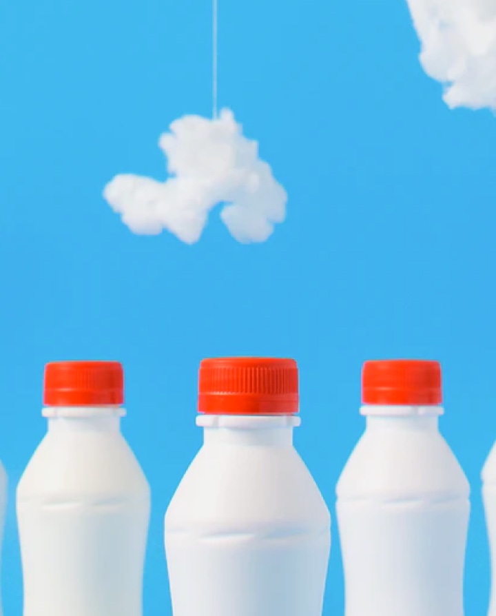 An image of milk bottles on the sky background